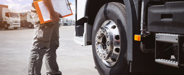 maintenance worker checking semi-truck