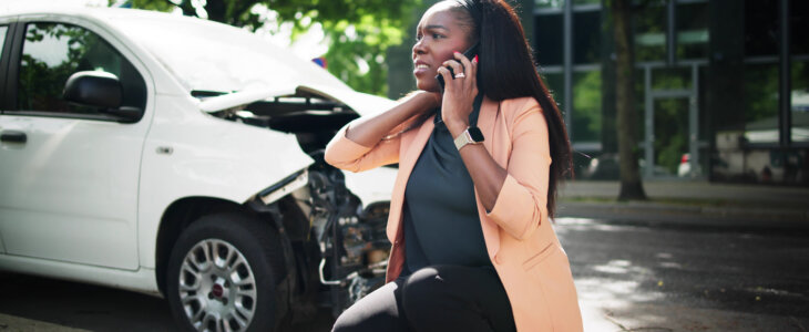 woman calling the police at the scene of an accident