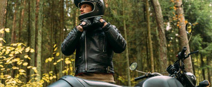 motorcycle rider putting on helmet