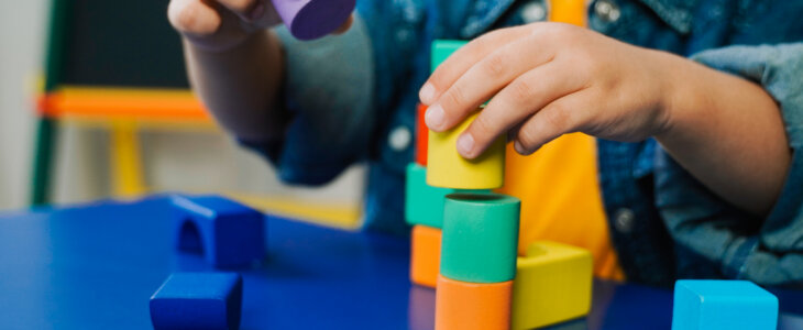 child playing with blocks at daycare