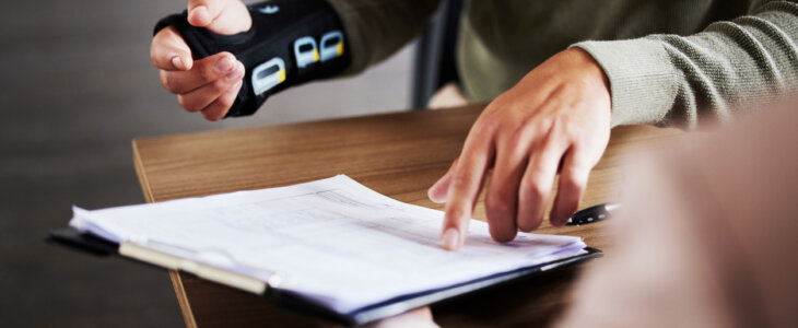 injured man with pre-existing condition signing settlement agreement