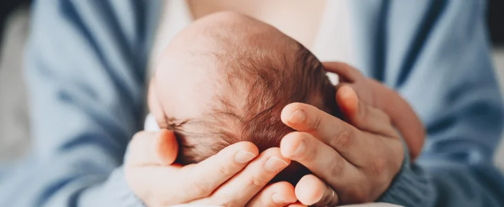 Mother holding her newborn child