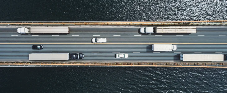 Trucks and cars on a bridge