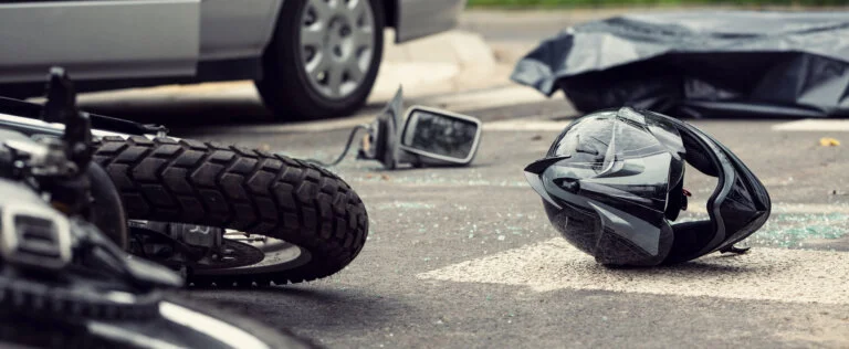 Motorcycle and helmet on the street after dangerous traffic incident