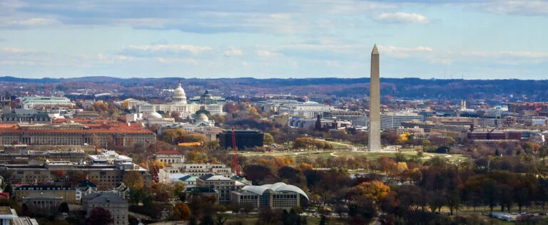 Washington DC skyline and monumnets seen from an observation deck in Arlington, Virginia. U.S. Capitol dome is at left, tall Washington Monument is at right.