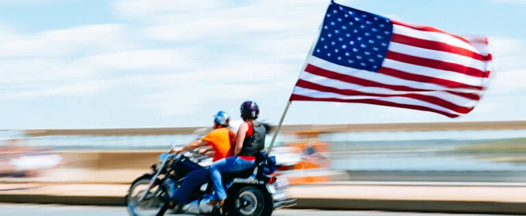 Washington DC, United States - May 25, 2014: Motorbike displaying american flag crosses the Arlington Memorial Bridge during the Rolling Thunder Ride on Memorial Day. Rolling Thunder is an annual motorcycle rally held annually in Washington DC to honor war heroes.