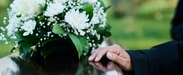 Parent wrongfully lost their child, holding casket