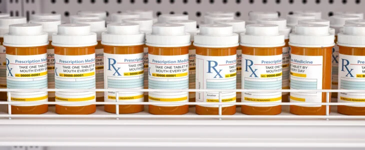 Row of drug bottles and pill tablet box on the farmacy shelf. 3d illustration