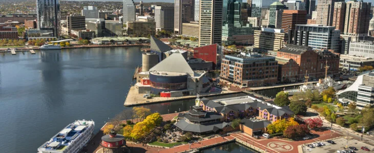 Downtown cityscape and marina on the Inner Harbor of Baltimore Maryland flowing out to the Patapsco River and Chesapeake Bay