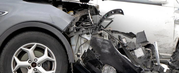 an accident on the road, the side of a dark car that was injured in a collision.