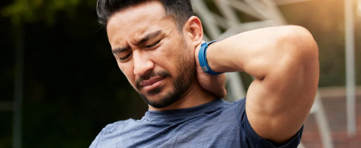 man injured in DC car accident rubbing the back of his neck