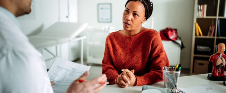woman talking to doctor about misdiagnosis.
